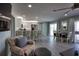 Open-concept living area with modern finishes, featuring a breakfast bar, stainless steel appliances, and sleek flooring at 1107 Shore View Dr, Englewood, FL 34223