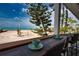 Outdoor porch seating area with amazing views of the beach and ocean at 1107 Shore View Dr, Englewood, FL 34223