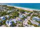 An aerial view of a beachside neighborhood with beautiful white sands and blue water at 113 Palm Ave, Anna Maria, FL 34216