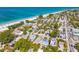 Beautiful aerial view of houses located near a white sand beach with blue ocean water at 113 Palm Ave, Anna Maria, FL 34216