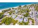 A beautiful aerial view of the neighborhood with a pristine beach and aqua-colored water at 113 Palm Ave, Anna Maria, FL 34216