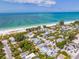 Aerial view of coastal neighborhood with white sandy beaches and turquoise ocean water at 113 Palm Ave, Anna Maria, FL 34216