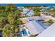 Aerial view of a neighborhood with backyard pools and beach access, near clear turquoise waters at 113 Palm Ave, Anna Maria, FL 34216