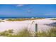Enjoy the beautiful white sand beach with an easy path to the water at 113 Palm Ave, Anna Maria, FL 34216