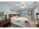 This bedroom is complete with a ceiling fan, wall decor and a wooden headboard at 113 Palm Ave, Anna Maria, FL 34216