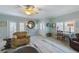 Inviting living room featuring neutral walls, tile flooring, and a ceiling fan providing ample lighting at 113 Palm Ave, Anna Maria, FL 34216