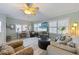Inviting living room with ceiling fan, tile flooring, desk and comfortable seating at 113 Palm Ave, Anna Maria, FL 34216