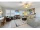 Bright and spacious living room with comfortable seating, ceiling fan, and TV at 113 Palm Ave, Anna Maria, FL 34216