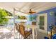 Charming outdoor patio with dining area and ceiling fan, perfect for relaxing near the pool at 113 Palm Ave, Anna Maria, FL 34216