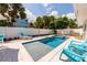 Relaxing backyard oasis featuring a pool, spa, and lounge chairs, perfect for sunny days at 113 Palm Ave, Anna Maria, FL 34216