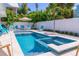 Sparkling pool with tiled spa offers a refreshing retreat in a beautifully landscaped backyard at 113 Palm Ave, Anna Maria, FL 34216
