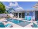 Beautiful backyard pool and spa with outdoor seating area, perfect for summer relaxation at 113 Palm Ave, Anna Maria, FL 34216