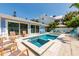 Beautiful backyard featuring a pool, spa, and lounge area, ideal for outdoor entertainment and relaxation at 113 Palm Ave, Anna Maria, FL 34216