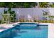 Backyard pool with attached spa and lounge area, surrounded by a white fence for privacy at 113 Palm Ave, Anna Maria, FL 34216