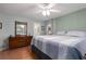 Charming main bedroom with wood flooring, modern ceiling fan, and bright windows at 11542 Summit Rock Ct, Parrish, FL 34219