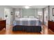 Well lit main bedroom with wood floors, a ceiling fan, and ensuite bathroom at 11542 Summit Rock Ct, Parrish, FL 34219