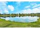 Enjoy the serene view of the community's pond, framed by the lush green landscape in the backyard at 11723 Cullen Park Ter, Bradenton, FL 34211