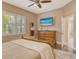 Bedroom featuring a ceiling fan, a large window, and wood flooring at 11723 Cullen Park Ter, Bradenton, FL 34211