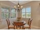Cozy breakfast nook with plantation shutters and chandelier lighting at 11723 Cullen Park Ter, Bradenton, FL 34211