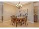 Elegant dining room with chandelier, artwork, and seating for six at 11723 Cullen Park Ter, Bradenton, FL 34211