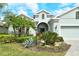 Beautiful single-story home with a well-manicured lawn, mature trees, and a two-car garage at 11723 Cullen Park Ter, Bradenton, FL 34211