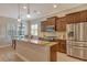 Well-lit kitchen with stainless steel appliances, breakfast nook, and granite countertops at 11723 Cullen Park Ter, Bradenton, FL 34211