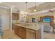 Open-concept design integrating the kitchen island with the living and dining areas at 11723 Cullen Park Ter, Bradenton, FL 34211