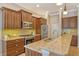 Gourmet kitchen with granite countertops, stainless steel appliances, and custom wood cabinetry at 11723 Cullen Park Ter, Bradenton, FL 34211
