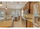 Bright kitchen with stainless steel appliances, granite counters, and views to the backyard and dining area at 11723 Cullen Park Ter, Bradenton, FL 34211