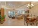 Spacious open-concept space with a dining area, living room, and kitchen, featuring tile floors at 11723 Cullen Park Ter, Bradenton, FL 34211