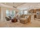 Open-concept living room featuring tile floors, comfortable seating, and access to the screened lanai at 11723 Cullen Park Ter, Bradenton, FL 34211