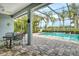 The screened lanai offers ample room for outdoor dining while enjoying views of the pool and pond at 11723 Cullen Park Ter, Bradenton, FL 34211