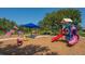 Community playground featuring slides, climbing structures, and a seesaw with safety mulch ground cover at 11723 Cullen Park Ter, Bradenton, FL 34211