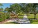 Community playground featuring a large yard, artwork, mature trees, and walking path at 11723 Cullen Park Ter, Bradenton, FL 34211
