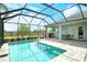 The beautiful pool area features a screened lanai and a view of the water at 11723 Cullen Park Ter, Bradenton, FL 34211