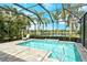 Inviting screened-in pool showcasing clear water, a brick-paver deck, and scenic lake view at 11723 Cullen Park Ter, Bradenton, FL 34211