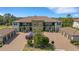 Aerial shot of condos with well-kept landscaping, paver parking, and detached garages amid lush scenery at 12405 Osorio Ct # 202, Sarasota, FL 34238