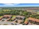 Panoramic aerial shot of a community with verdant landscaping and diverse housing options under a bright sky at 12405 Osorio Ct # 202, Sarasota, FL 34238
