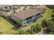 Scenic aerial view of the condos, showcasing the rear of building, landscape, and tile roof at 12405 Osorio Ct # 202, Sarasota, FL 34238