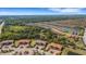 Picturesque aerial view of a Primary-planned community featuring lush landscaping and a tranquil lake at 12405 Osorio Ct # 202, Sarasota, FL 34238