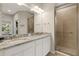 Bathroom featuring dual sinks, a granite countertop, a shower and ample counterspace at 12405 Osorio Ct # 202, Sarasota, FL 34238