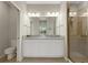 Bathroom features granite countertops, double sinks, vanity, and a glass-enclosed shower at 12405 Osorio Ct # 202, Sarasota, FL 34238