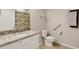 Bright bathroom features a granite countertop, single sink, and convenient access bars for accessibility at 12405 Osorio Ct # 202, Sarasota, FL 34238