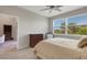 Cozy bedroom with natural light, a dresser, and a serene view of trees and blue skies at 12405 Osorio Ct # 202, Sarasota, FL 34238