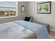 Cozy bedroom features a comfortable bed, sitting chair, and natural light at 12405 Osorio Ct # 202, Sarasota, FL 34238