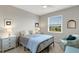Well-lit bedroom with a ceiling fan, large window, and comfortable decor at 12405 Osorio Ct # 202, Sarasota, FL 34238