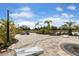 Beautiful courtyard with string lights, outdoor seating, and a view of the lake, perfect for relaxing and entertaining at 12405 Osorio Ct # 202, Sarasota, FL 34238