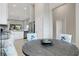 Bright dining area open to the kitchen with natural light, featuring stylish chairs and a wooden table at 12405 Osorio Ct # 202, Sarasota, FL 34238