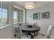 Bright dining area with natural light, featuring stylish chairs and a round wooden table at 12405 Osorio Ct # 202, Sarasota, FL 34238