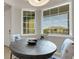 Bright dining area with natural light, featuring stylish chairs and a round wooden table at 12405 Osorio Ct # 202, Sarasota, FL 34238